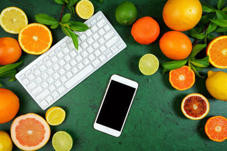 Tangentbord, smartphone och citrus