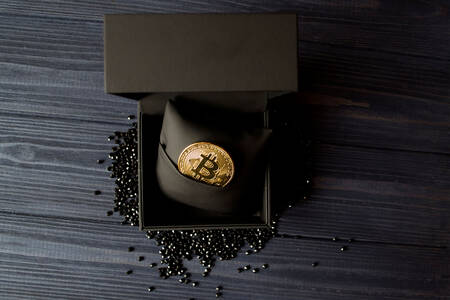 Golden bitcoin in black box