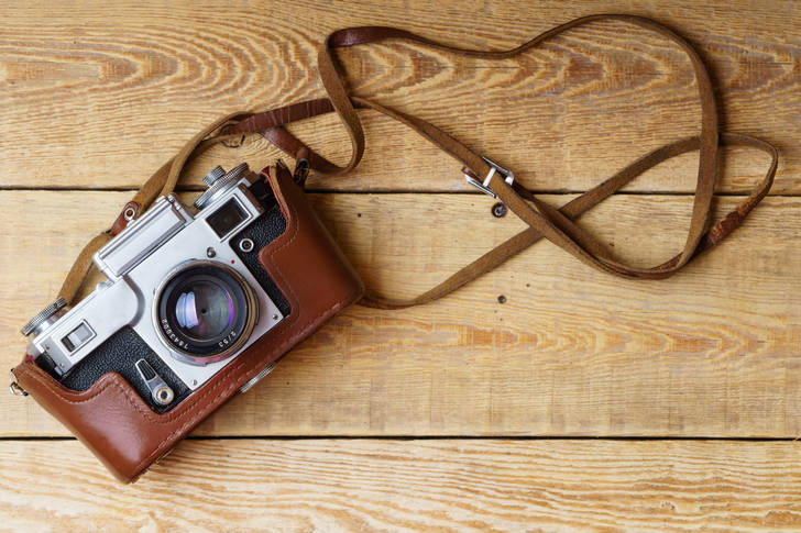 Old retro camera on wooden boards