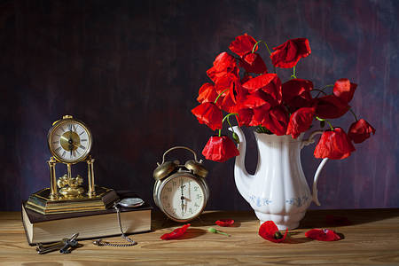 Vintage Uhr und Mohnblumen auf dem Tisch