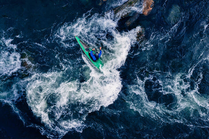A kayaker on a turbulent mountain river