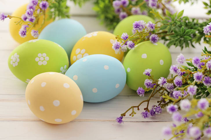 Easter eggs on a table with flowers
