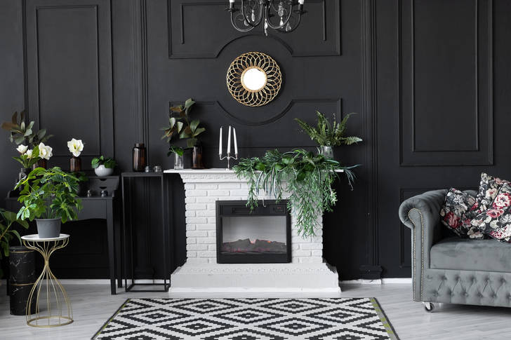 White fireplace on a black wall background
