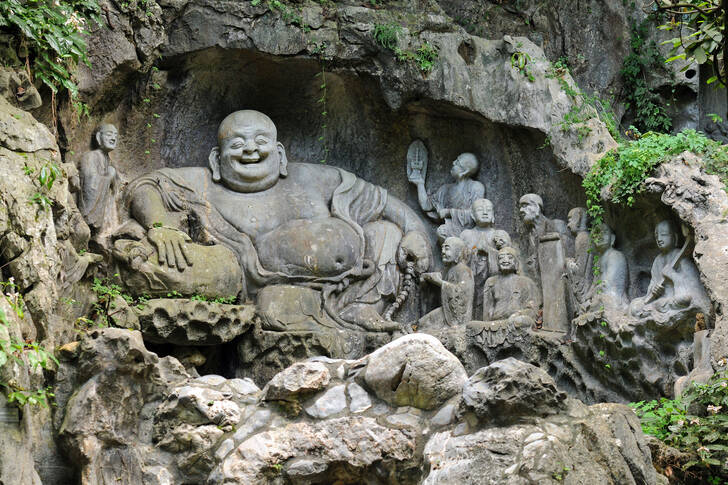 Laughing Buddha statue in rock