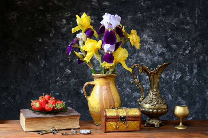 Irises and strawberries on the table