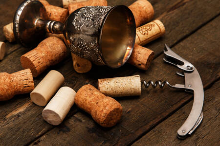 Cup, wine corks and corkscrew