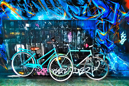 Bicycles against a wall with graffiti