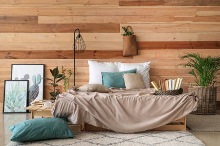Wooden wall in the interior of the bedroom