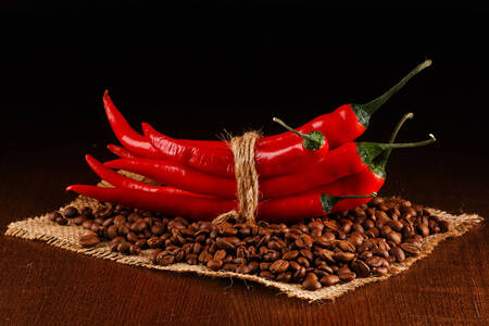 Chili peppers on coffee beans