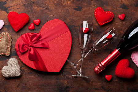 Heart-shaped gift, glasses and champagne