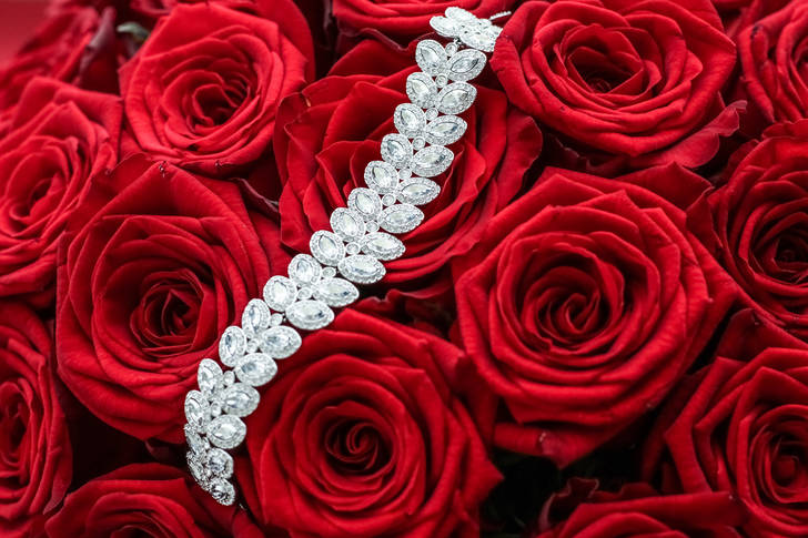 Luxurious bracelet on red roses