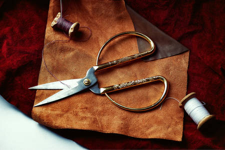 Scissors and threads on leather flaps