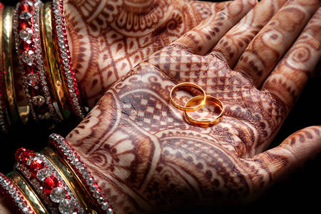 Wedding rings in the palms of the bride