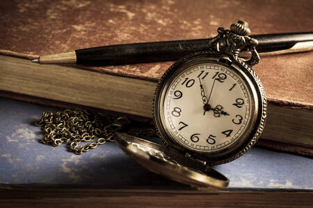 Pocket watch, book and pen