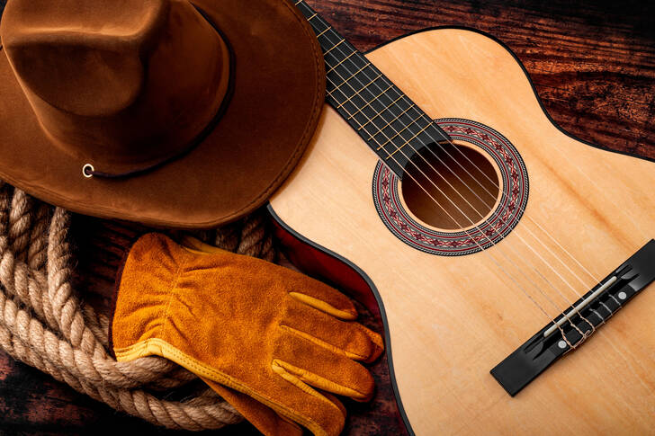 Cowboy hat, guitar and gloves