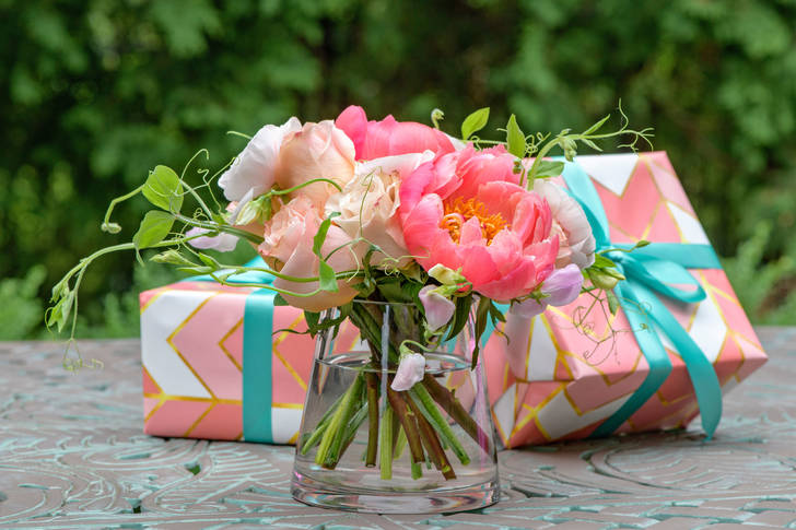 Bouquet of roses and peonies and gifts