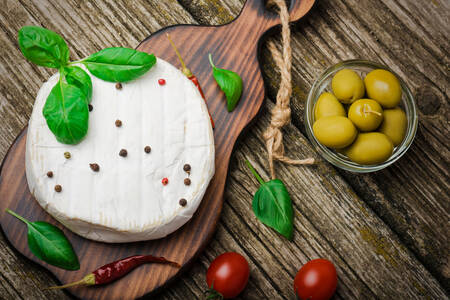 Camembert with basil leaves and olives