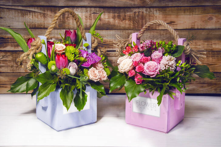 Bouquets of flowers in wooden boxes