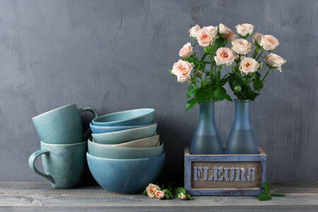 Roses in vases and ceramic dishes