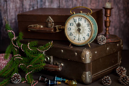 Vintage retro style alarm clock and old fashioned suitcases