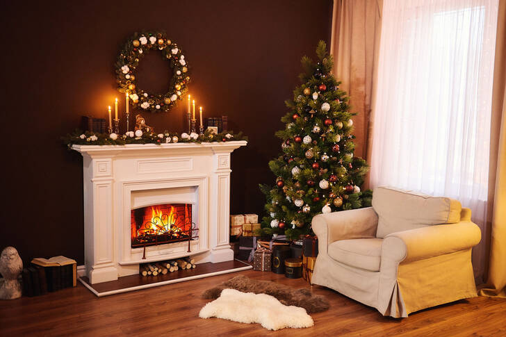 Living room with fireplace, Christmas tree and candles