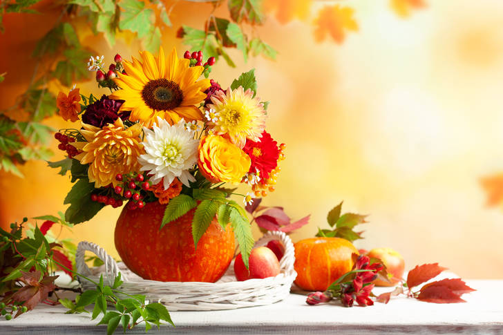 Bouquet of flowers and berries in a pumpkin