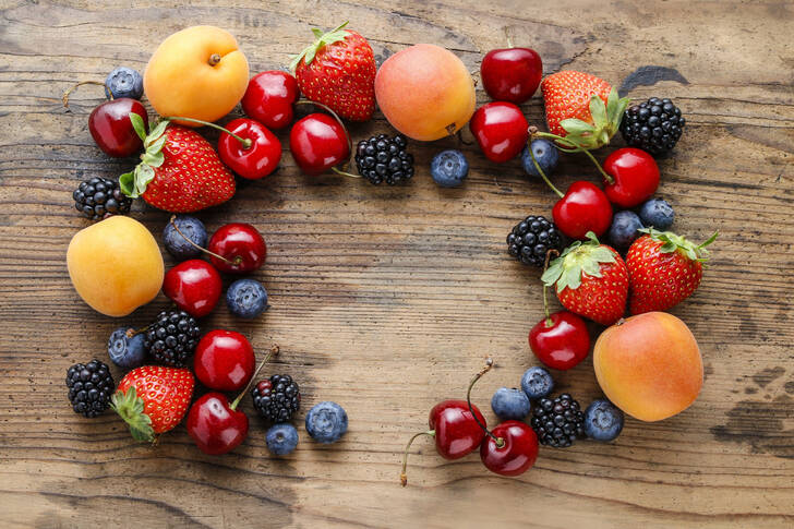 Fruits and berries on wooden background