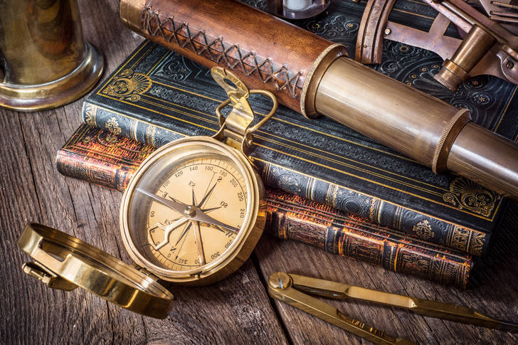 Compass, spyglass and old books