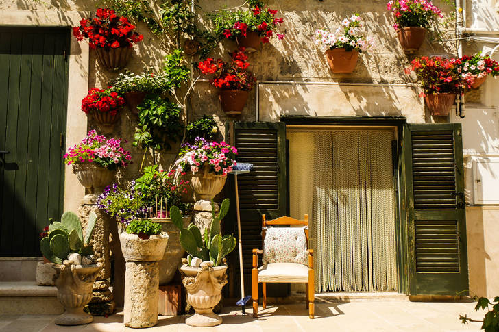 Facade of an old house with flowers