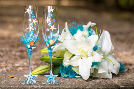 Wedding glasses and a bouquet in a nautical style