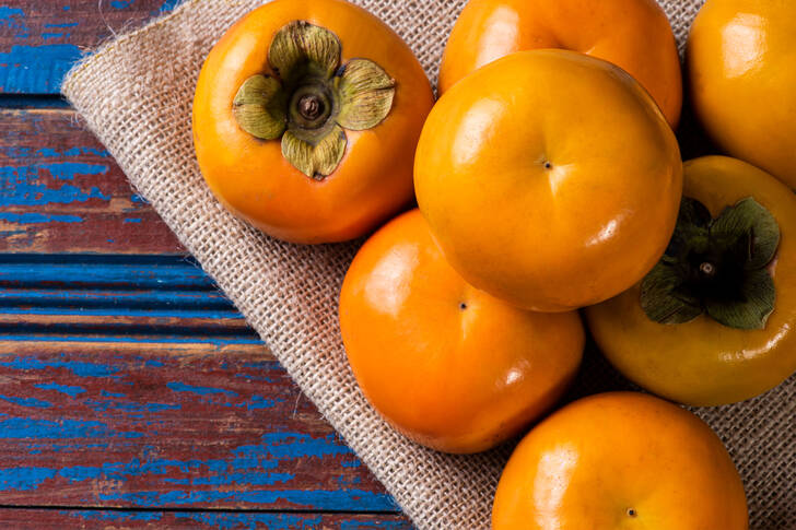 Ripe persimmon on a wooden table