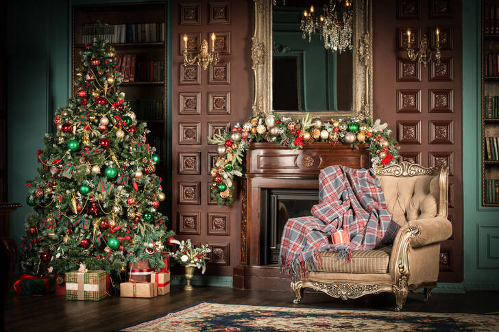 Christmas tree and armchair by the fireplace