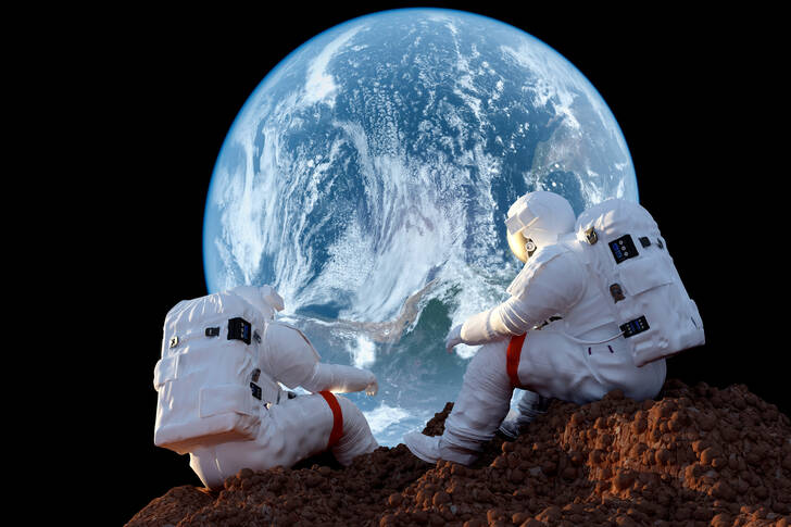 Astronauti na pozadí planety