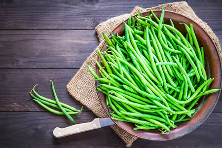 Green beans on wooden background