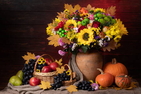Fruits, pumpkins and flowers on the table