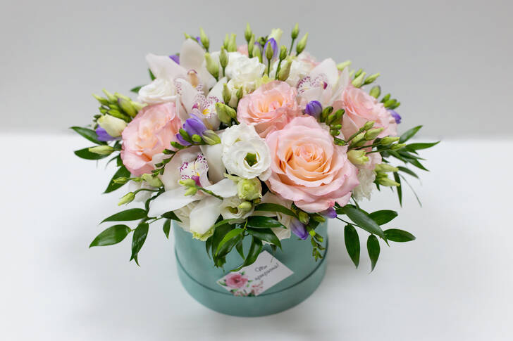 A bouquet of pink roses and orchids