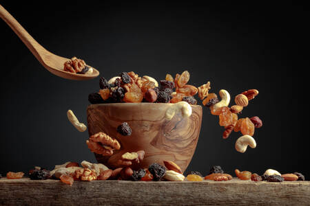Nuts and raisins in a wooden bowl