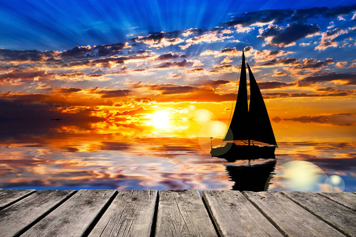 Sailboat at sea at sunset