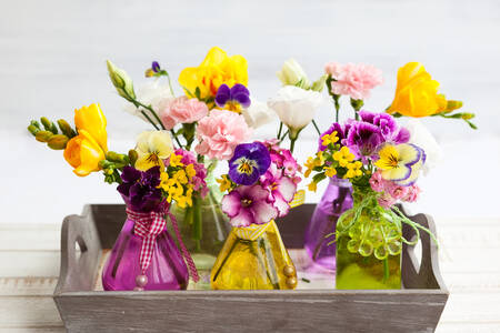 Bouquets in glass bottles