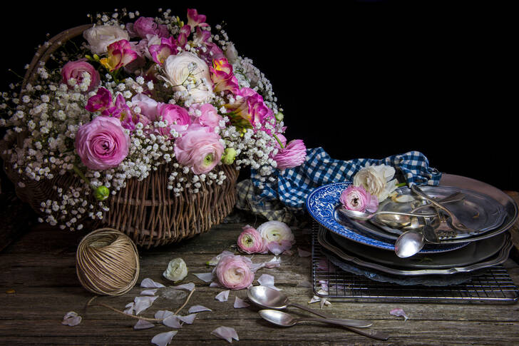 Bouquet of flowers in a basket on the table