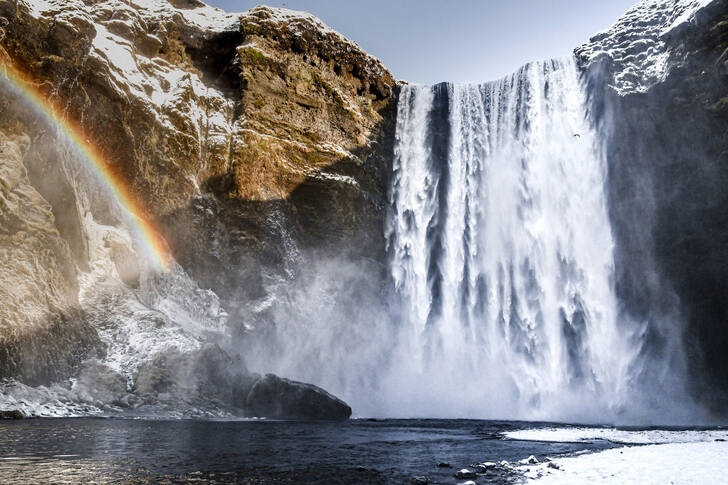 Skógafoss waterfall in the sunlight