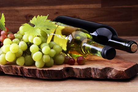 Grapes and wine on a wooden board