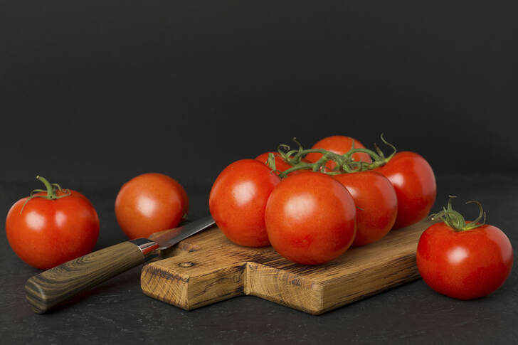 Fresh tomatoes on a wooden board