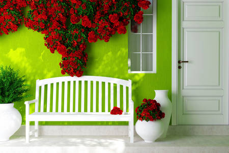 Piros rózsák egy világos zöld házon