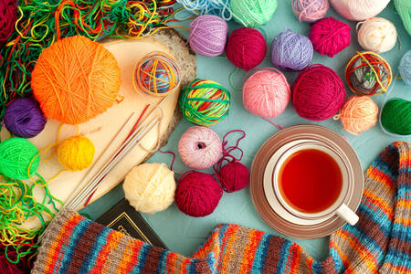 Multicolored yarn and a cup of tea