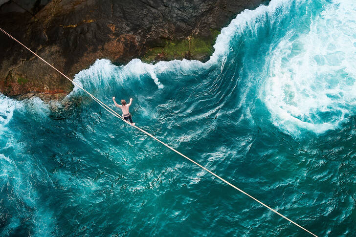 A tightrope walker over the ocean