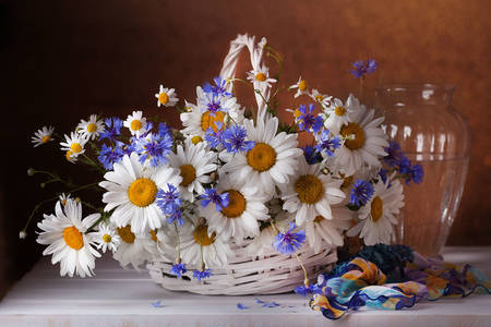 Chamomile and cornflowers in a basket