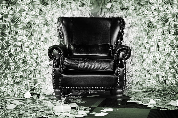 Leather armchair on the background of dollars