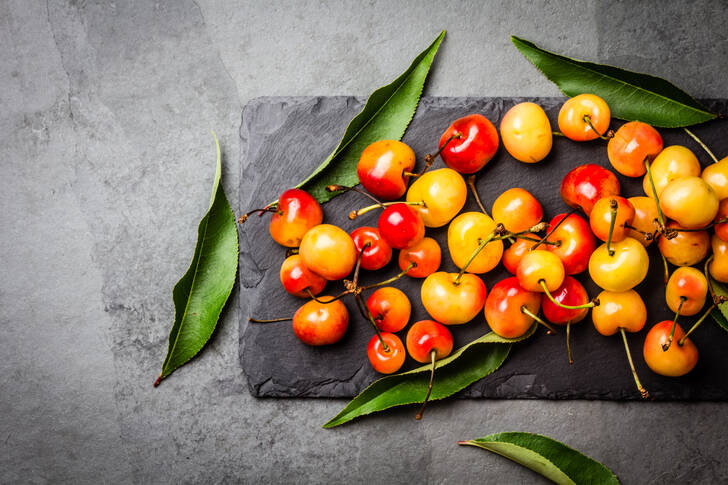 Yellow cherries on a stone plate