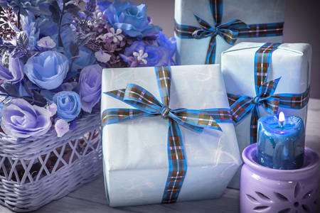 Gifts with blue ribbons and flowers